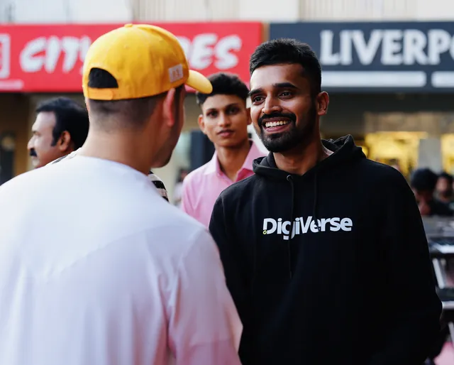 Abhijith in a Digiverse hoodie talking with people at an event