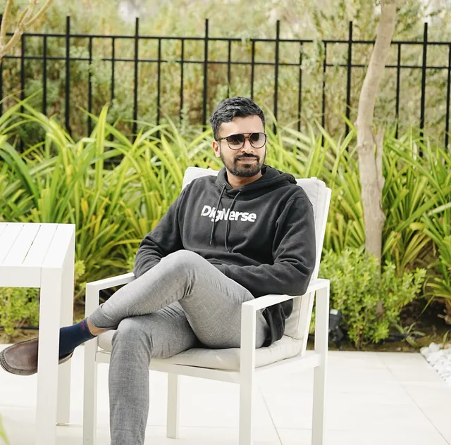 Abhijith seated outdoors in a Digiverse hoodie